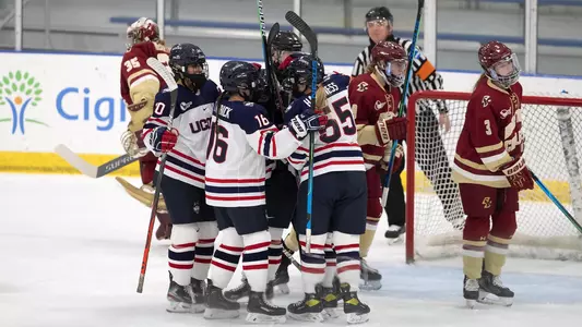 The Huskies celebrate after a Savannah Bouzide goal against BC on December 4 in Storrs.