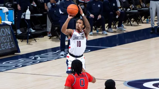 Brendan Adams takes a three-pointer against St. John's on January 18.