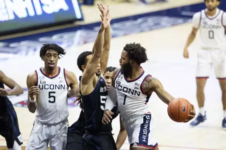 Rj Cole drives the lane and looks to pass in the game against Butler on January 26th at Gampel Pavilion