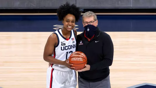 Christyn Williams accepts a basketball commemorating her 1,000th-career point prior to the game against Providence on January 9, 2021.