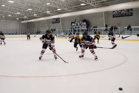 UConn players race to the puck in the game against Merrimack on October 29