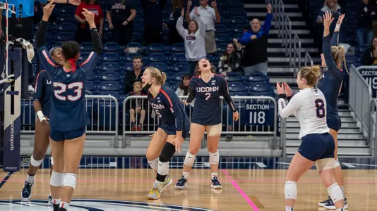 The women's volleyball team celebrating at Butler