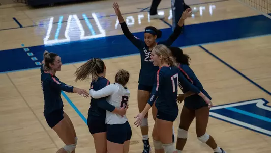 The volleyball team celebrating after a point at Villanova