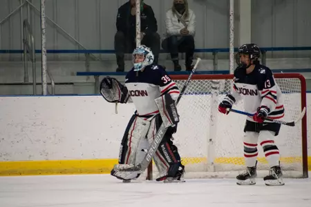 UConn goalie and defender in position to prevent a goal