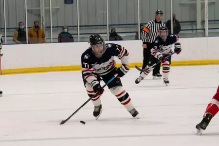 Amy Landry takes the puck up the ice against BU