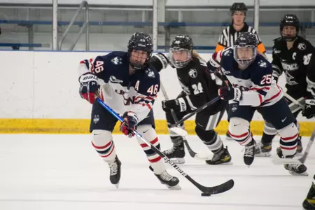 Danielle Fox takes the puck against providence
