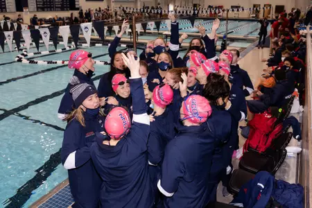 The team gathers for their pre meet cheer