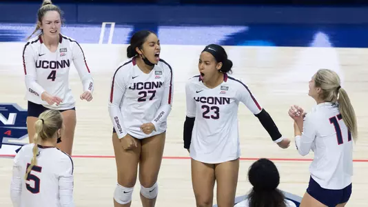 The volleyball team celebrating after a point