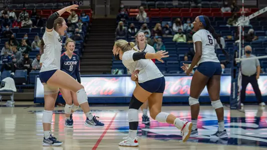 Mia Ruffolo and McKayla Wuensch celebrating after a block