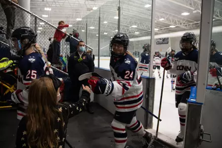 UConn player fist bumps fan after the game