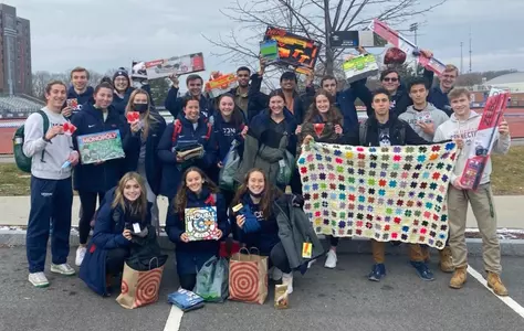 The women's and men's rowing programs participating in a food drive