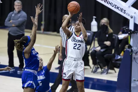 Evina Westbrook rises for the shot over two defenders in the game against Seton hall at gampel pavilion on February 10th
