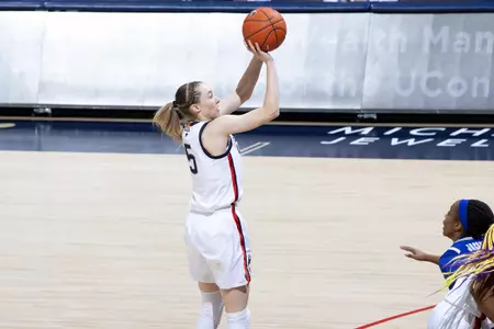Paige Bueckers takes the 3 point shot over the defender in the game against Seton hall at gampel pavilion on February 10th