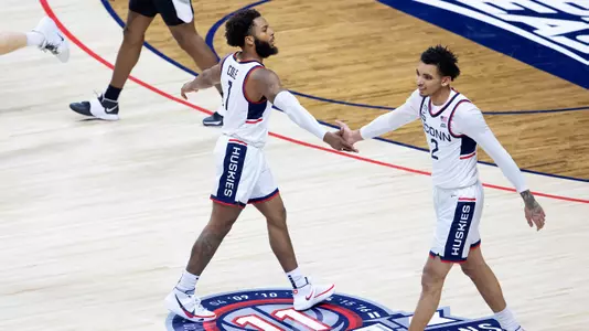 R.J. Cole and James Bouknight slap hands against Providence on February 16, 2021.