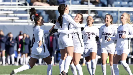 Kess Elmore celebrates with her teammates after scoring UConn's first goal of the season.