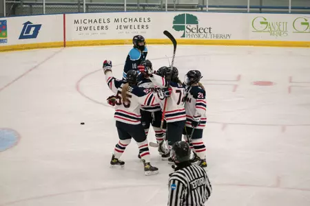 The Huskies celebrate after a Natalie Snodgrass goal.