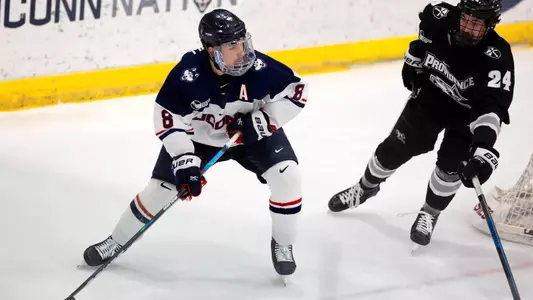 Carter Turnbull looks for a teammate during the Hockey East Quarterfinal matchup against Providence on March 14, 2021.