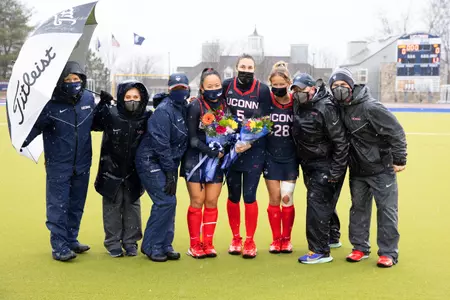 The 3 seniors and coaches come together to take a photo after the senior celebrations
