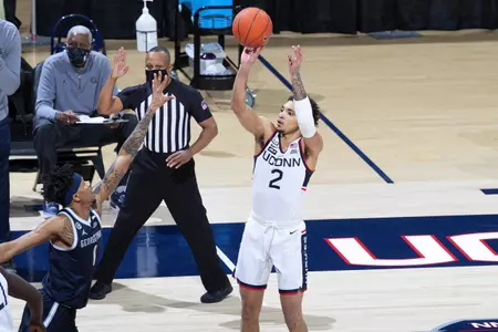 James Bouknight rises over the defender for the shot in the game against Georgetown at Gampel Pavilion on March 6th 2021