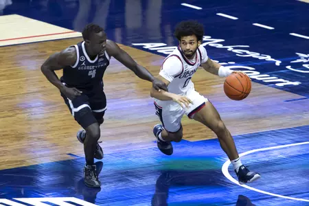 Jalen Gaffney dribbles past the defender in the game against Georgetown at Gampel Pavilion on March 6th 2021