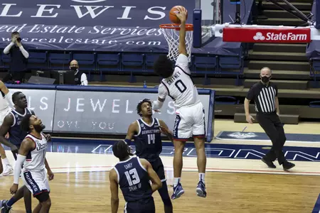 Jalen Gaffney rises for the dunk in the game against Georgetown at Gampel Pavilion on March 6th 2021