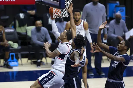 Tyrese Martin drives in for the layup in the game against Georgetown at Gampel Pavilion on March 6th 2021
