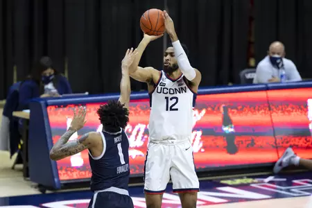 Tyler Polley rises for the 3 in the game against Georgetown at Gampel Pavilion on March 6th 2021