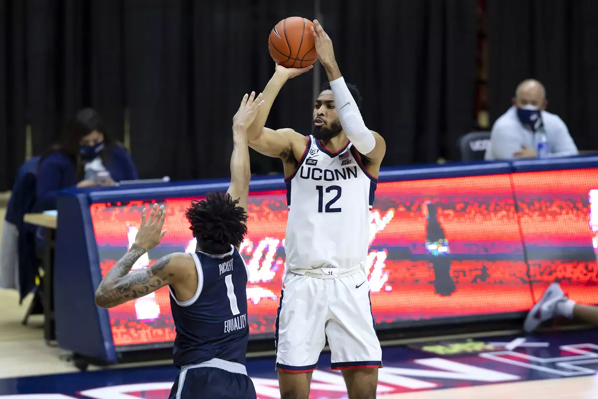 Tyler Polley rises for the 3 in the game against Georgetown at Gampel Pavilion on March 6th 2021