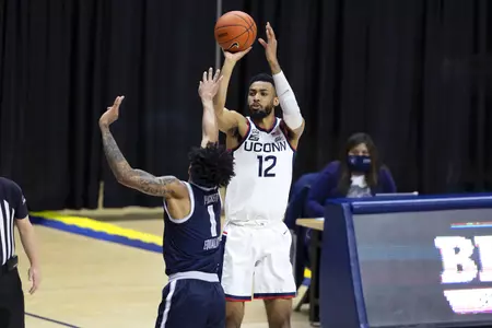 Tyler Polley rises for the shot over the defender in the game against Georgetown at Gampel Pavilion on March 6th 2021