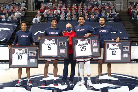 The 4 seniors and Coach Hurley come together for a picture after the senior night celebrations at gampel pavilion on March 6th