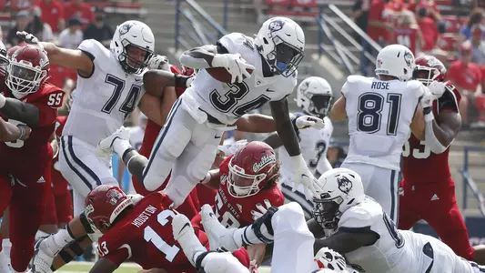 Connecticut running back Kevin Mensah goes up high for a short gain against Fresno State during the first half of an NCAA college football game in Fresno, Calif., Saturday, Aug. 28, 2021. (AP Photo/Gary Kazanjian)