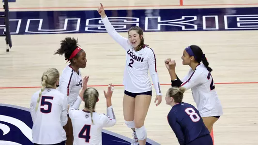The volleyball team celebrating after a point
