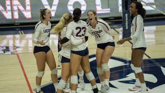 Members of the volleyball team celebrating after a point