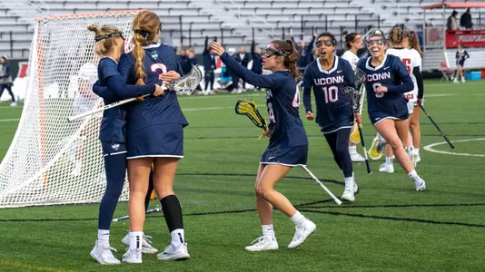 Women's lacrosse players celebrating after a goal at Fairfield