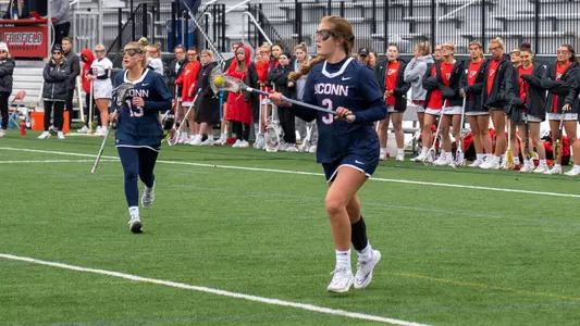 Grace Coon holding the ball while Stephanie Palmucci stands nearby