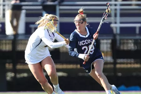 Kate Shaffer with the ball as a defender guarding her