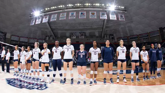 The volleyball team lined up during the National Anthem