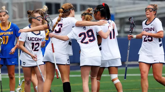 The women's lacrosse team celebrating after a goal