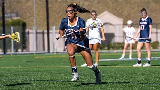 Sydney Watson looking to pass with a defender nearby