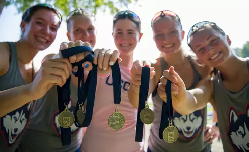 Members of the UConn Rowing pose with their medals at the Head of the Riverfront in Hartford, CT
