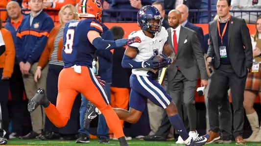 Connecticut wide receiver Skyler Bell (1) catches a pass in front of Syracuse defensive back Justin Barron (8) during the first half of an NCAA football game on Saturday, Nov. 23, 2024 in Syracuse, N.Y.