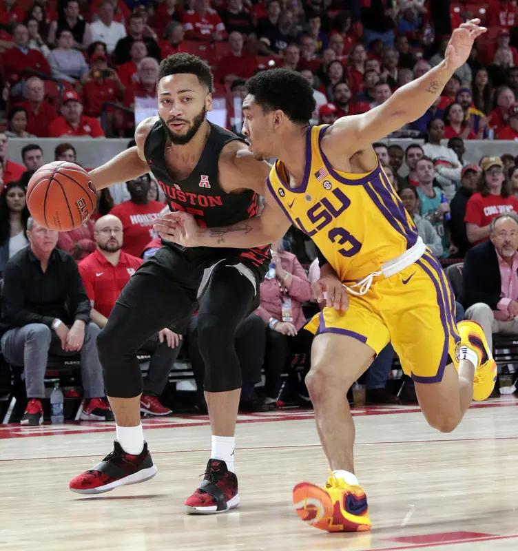 Houston guard Galen Robinson Jr. (25) drives down court as LSU guard Tremont Waters (3) defends during the first half of an NCAA college basketball game Wednesday, Dec. 12, 2018, in Houston. (AP Photo/Michael Wyke)