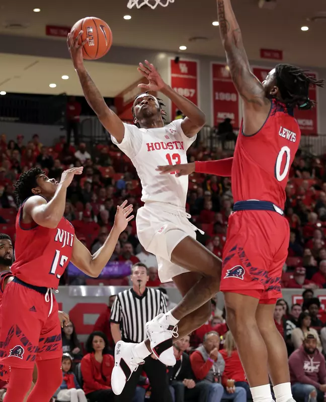 Houston guard Dejon Jarreau (13) shoots between New Jersey Institute of Technology guard Diandre Wilson (15) and forward Abdul Lewis (0) during the first half of an NCAA college basketball game Saturday, Dec. 29, 2018, in Houston. (AP Photo/Michael Wyke)