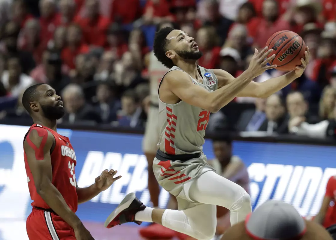Houston's Galen Robinson Jr., right, heads to the basket past Ohio State's Keyshawn Woods during the first half of a second round men's college basketball game in the NCAA Tournament Sunday, March 24, 2019, in Tulsa, Okla. (AP Photo/Jeff Roberson)
