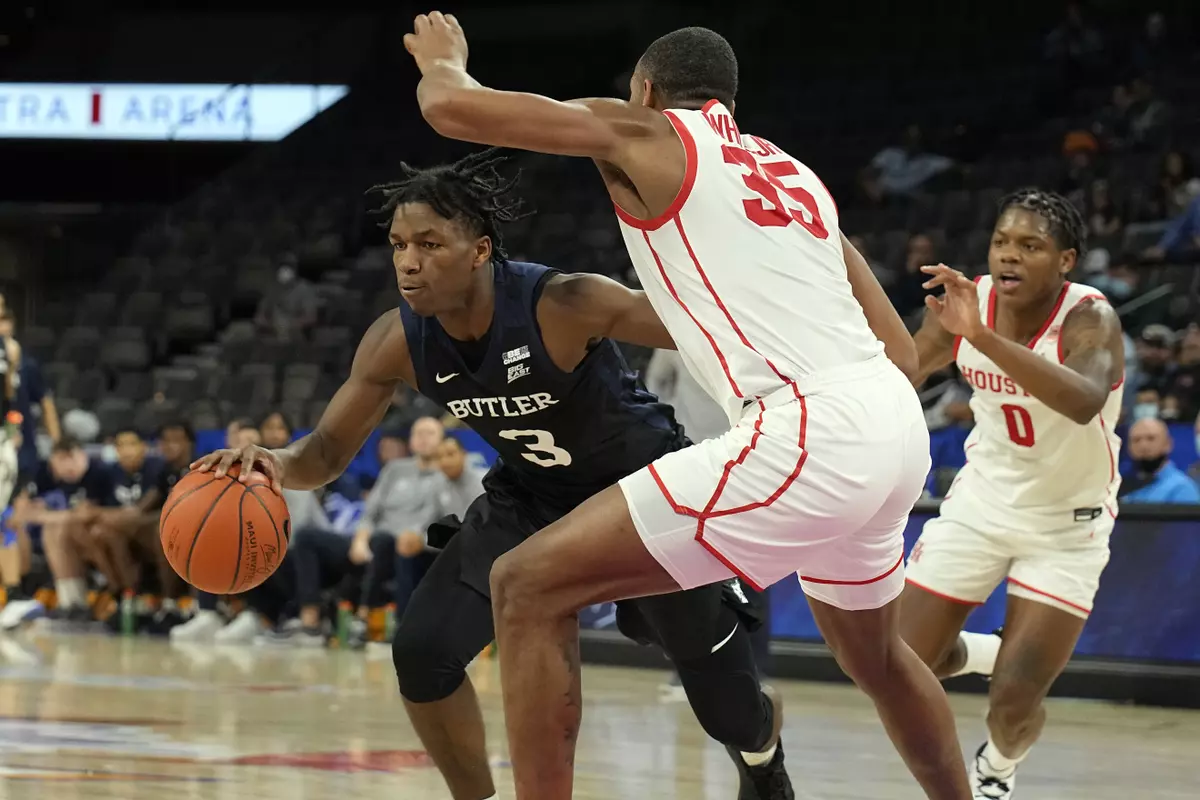 Butler guard Chuck Harris (3) drives past Houston guard Marcus Sasser and forward Fabian White Jr. (35) in the first half during an NCAA college basketball game at the Maui Invitational in Las Vegas, Monday, Nov. 22, 2021. (AP Photo/Rick Scuteri)