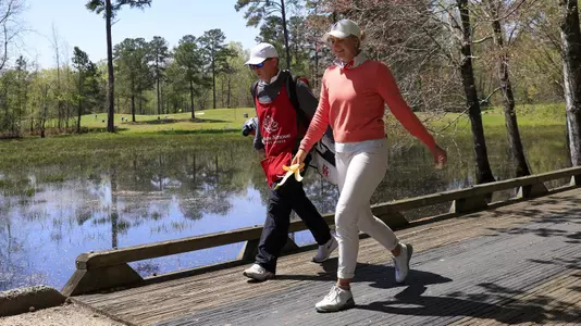 Karen Fredgaard of Denmark and her caddie walk over the bridge on the No. 4 hole during Round 2 of the Augusta National Women's Amateur, Thursday, April 1, 2021.