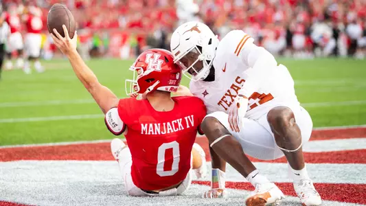 Joseph Manjack IV holds ball up after hauling in catch vs Texas