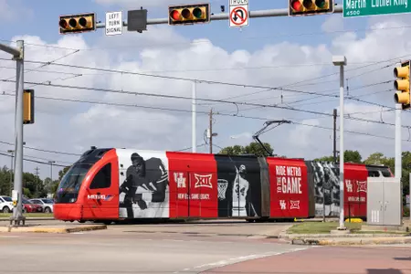 Big 12 Metro Train Wrap, Ride Metro to the Game checker design on the purple line. July 20, 2023.