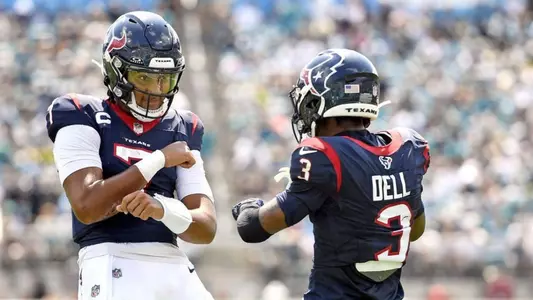 Tank Dell celebrate with CJ Stroud