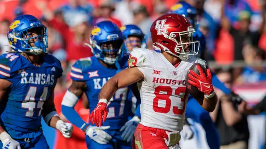 Oct 19, 2024; Kansas City, Missouri, USA; Houston Cougars wide receiver Mekhi Mews (83) scores a touchdown against the Kansas Jayhawks during the second quarter at GEHA Field at Arrowhead Stadium. Mandatory Credit: William Purnell-Imagn Images